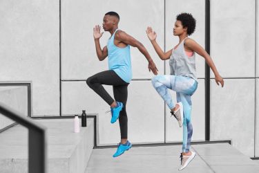 motivated-active-ethnic-couple-run-up-stairs-together-jump-highly-train-climbing-staircase-city-wear-comfortable-sportsclothes-drink-water-from-bottle-climb-challenge-choose-difficult-path-scaled.jpg